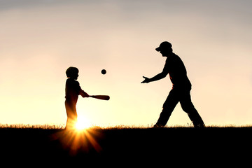 Fototapeta na wymiar Silhouette of Father and Son Playing Baseball Outside