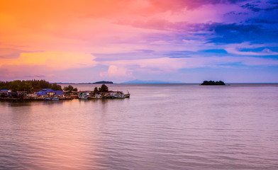 Fototapeta premium Fishing village on the sea with sky in Thailand with filtered co
