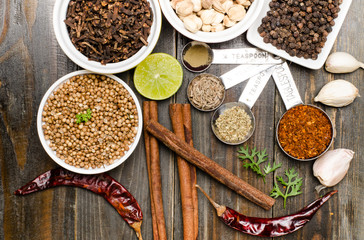 Herbs and spices on wooden background