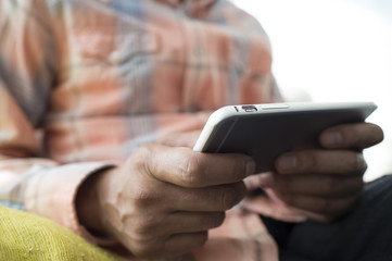 Men are sending the e-mail sitting on the sofa