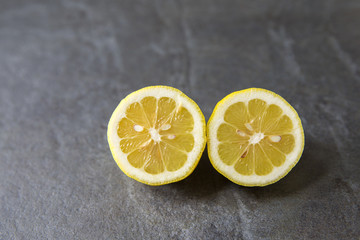 Juicy lemons on slate background