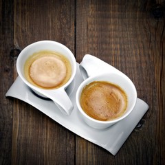 Two White Cups Of Espresso Together On The One Plate