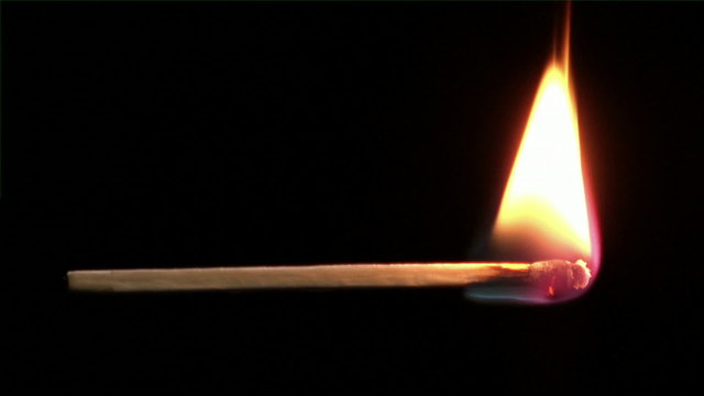 Close-Up footage of a match igniting and burning as it rotates