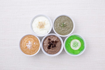variety of body scrubs on cotton background