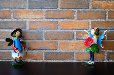 Background of a brick wall with doll stand