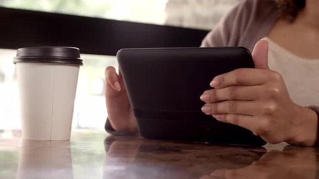 Woman using a Tablet in a Cafe