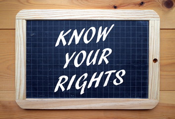 The phrase Know Your Rights in white text on a blackboard