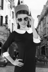 beautiful brunette woman in a retro style with sunglasses