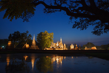 Fototapeta na wymiar Night in Sukhothai historical park. Buddhist temple ruins in Su
