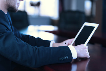 Businessman working with tablet in office, closeup
