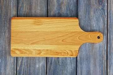 Cutting board on wooden background