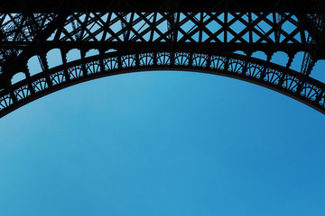 Eiffel Tower structure detail isolated against blue sky with cop