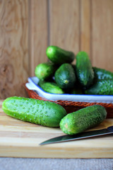Cucumber lying on the plate on the board..