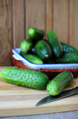 Cucumber lying on the plate on the board..