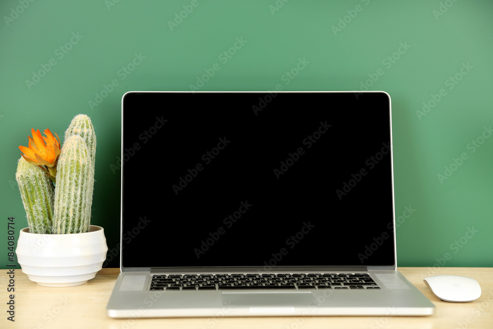 Sticker laptop on table, on green blackboard background