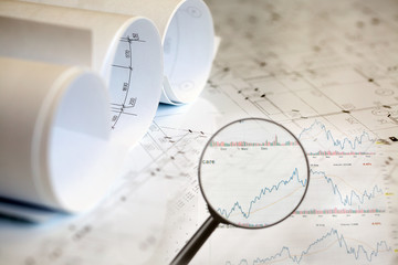 Collage with construction plans, graphs and charts
