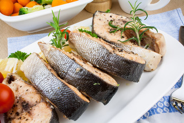 Grilled salmon steaks and vegetables