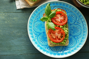 Vegan sandwich with avocado and vegetables on plate