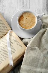 Still life with cup of coffee and book, close up
