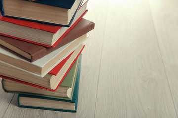 Stack of books on wooden background