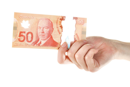 Female hand with Canadian 50 Dollar, isolated on white