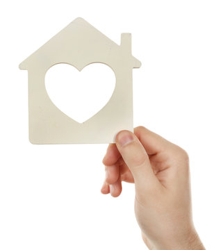 Female hand holding house isolated on white