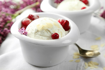 Beautiful composition with tasty ice cream and lilac flowers