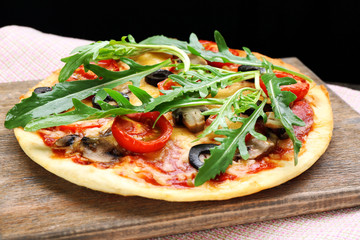 Tasty pizza with vegetables and arugula 