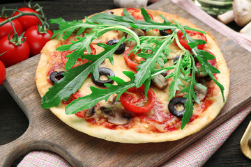 Tasty pizza with vegetables and arugula 