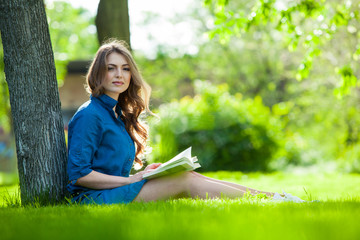 Girl reading a book in park