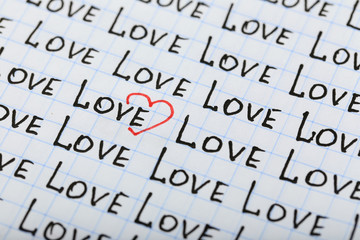 Words LOVE written on sheet of paper background