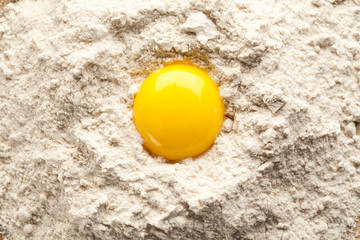 Fototapeta na wymiar Egg yolk on buckwheat flour.
