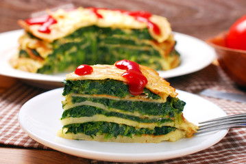 slice of pancake cake with spinach