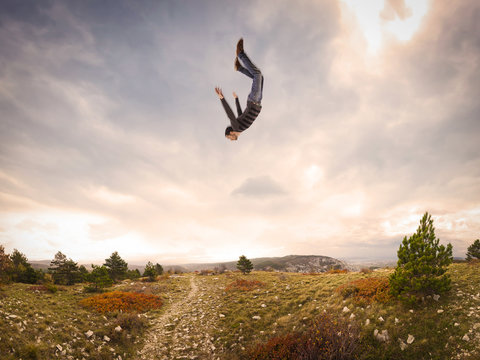 Man Falling Down From The Sky In Autumnal Landscape