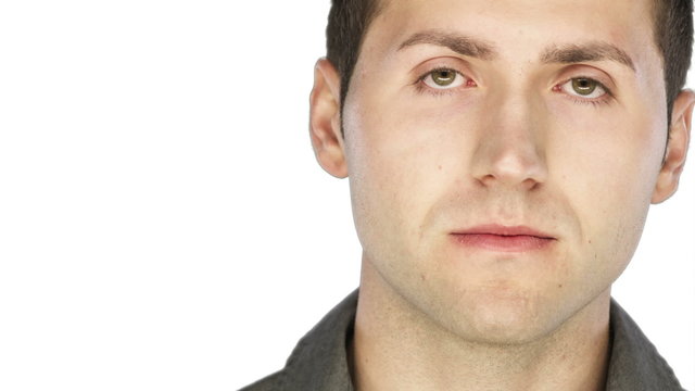 Man looks serious into the camera on a white background