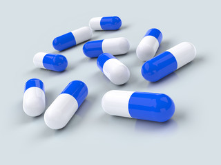 Group of blue pills isolated on gray background. 