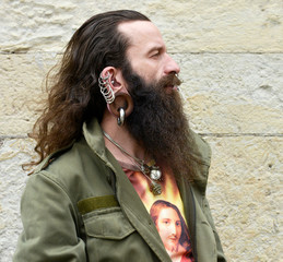Naklejka premium Profil of a long bearded pierced Man