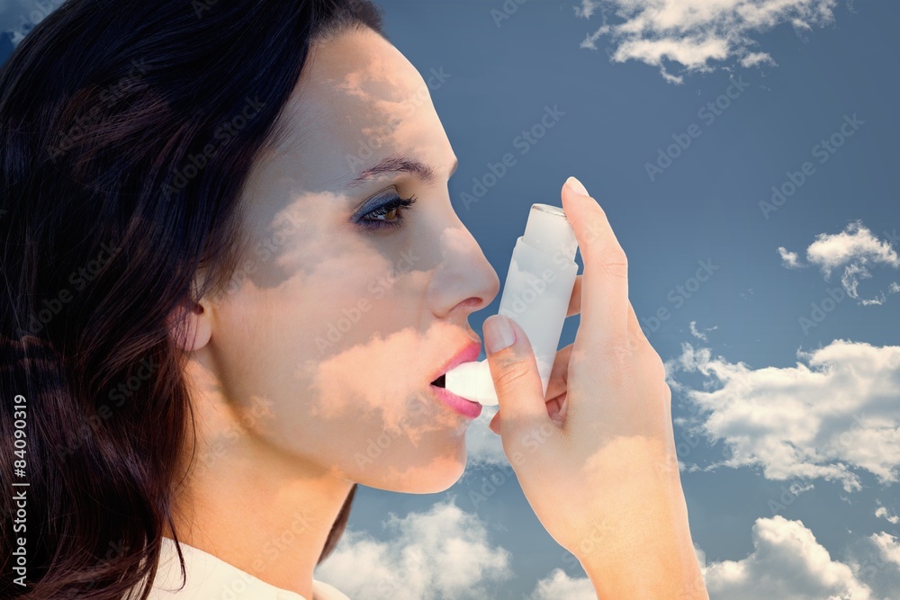Poster Composite image of asthmatic brunette using her inhaler 
