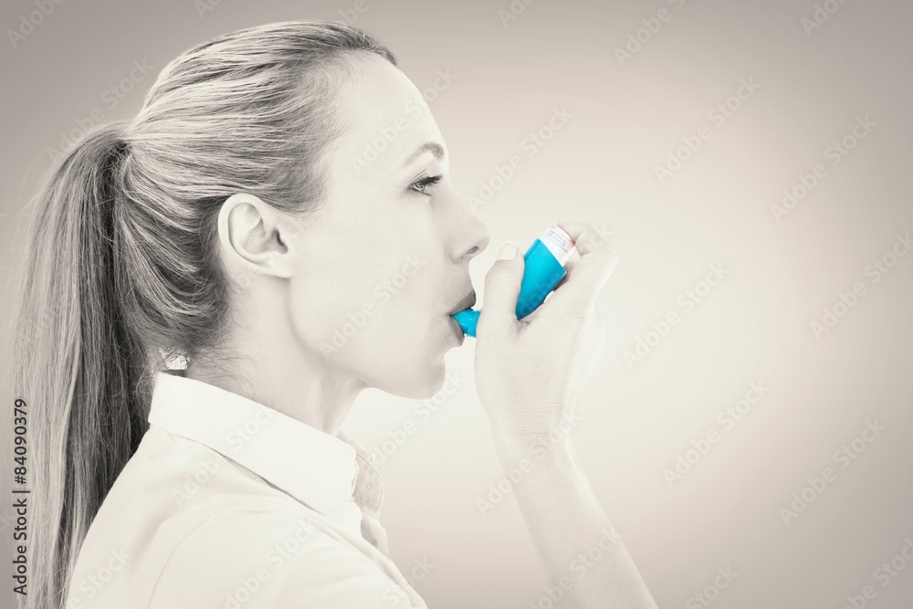 Poster Composite image of pretty blonde using an asthma inhaler