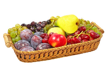 Fresh fruits on a straw pot.Isolated.