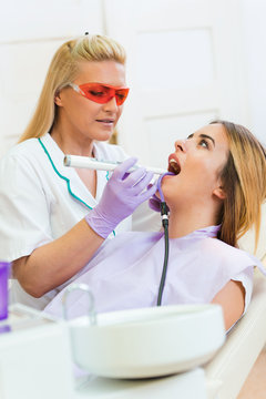 Dentist examining teeth at dental office