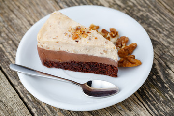 Tasty nuts cake on wooden background.