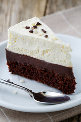 Vanilla cheesecake slice on wooden background.