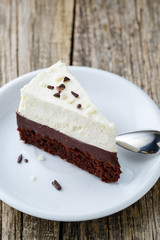 Vanilla cheesecake slice on wooden background.