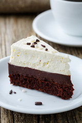 Vanilla cheesecake slice on wooden background.