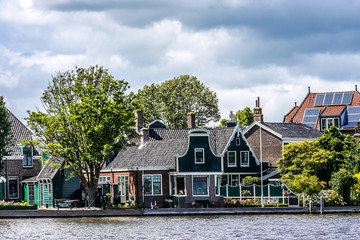 Dutch rural scenery: small village on river shore in Zaandam.