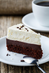 Vanilla cheesecake slice on wooden background.
