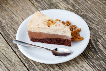 Tasty nuts cake on wooden background.