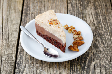 Tasty nuts cake on wooden background.