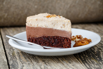 Tasty nuts cake on wooden background.